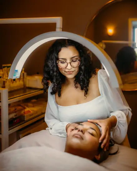 Yarely giving a facial in the Flawless treatment room